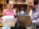 At Rock Bridge Elementary School in Columbia, Missouri, second grader Riley Samuel asks her question of ISS crew member Mike Hopkins, KF5LJG, as Don Moore, KM0R, handles the controls for the March 5, 2014, ARISS contact. [Bill McFarland, N0AXZ, photo]